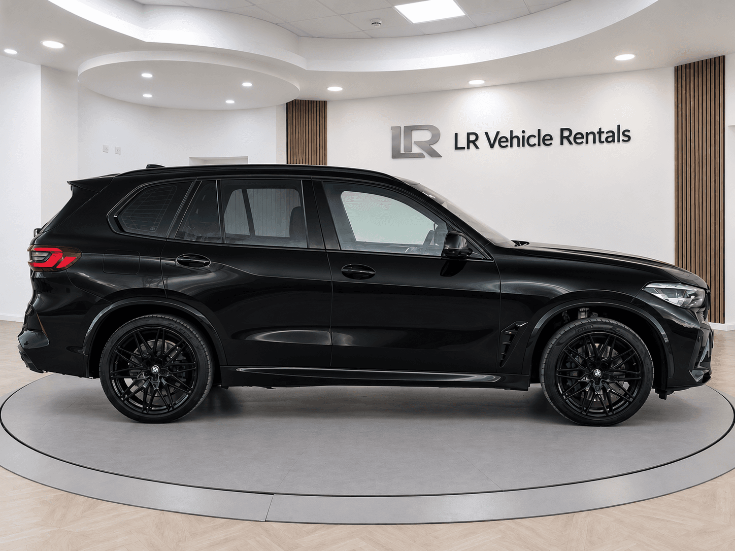 Black BMW X5 M Competition shown side-on in the LR Vehicle Rentals studio